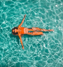 woman swimming alone in body of water